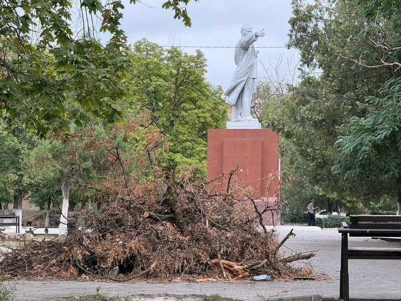 На площади у ДК рядом с памятником Ленину лежит большая куча веток после урагана